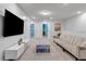 Upstairs bonus room with sectional sofa and large TV at 7424 Oakmoss Loop, Davenport, FL 33837