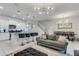 Open living space with gray sectional sofa and view of dining area at 7424 Oakmoss Loop, Davenport, FL 33837