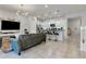 Open living room and kitchen with island at 7424 Oakmoss Loop, Davenport, FL 33837