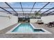 Private rectangular pool with covered patio and lounge chairs at 7424 Oakmoss Loop, Davenport, FL 33837