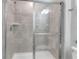 Clean shower with glass enclosure and gray tile at 7424 Oakmoss Loop, Davenport, FL 33837