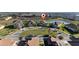 Aerial view of home nestled in a community by a lake at 8990 Ace Loop, Davenport, FL 33896