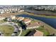 Aerial view of home community with lake and houses at 8990 Ace Loop, Davenport, FL 33896