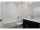 Bathroom with a shower/tub combo, dark vanity, and tile flooring at 8990 Ace Loop, Davenport, FL 33896