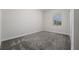 Simple bedroom with gray carpet and window coverings at 8990 Ace Loop, Davenport, FL 33896