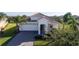 One story house with tile roof and a two car garage at 8990 Ace Loop, Davenport, FL 33896