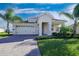 One-story house with a two-car garage and a landscaped yard at 8990 Ace Loop, Davenport, FL 33896