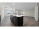 Open concept kitchen with island and stainless steel appliances at 8990 Ace Loop, Davenport, FL 33896