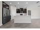 Modern kitchen with dark cabinetry, stainless steel appliances, and an island at 8990 Ace Loop, Davenport, FL 33896
