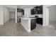 Modern kitchen with dark cabinets and a breakfast bar at 8990 Ace Loop, Davenport, FL 33896
