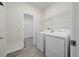 Laundry room with washer, dryer and shelving at 8990 Ace Loop, Davenport, FL 33896
