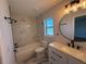Spa-like bathroom with marble tile and a walk-in shower at 911 Pine Ave, Mount Dora, FL 32757