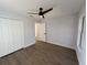 Spacious bedroom with double doors leading to a closet and wood-look floors at 911 Pine Ave, Mount Dora, FL 32757
