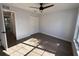 Bedroom with wood-look floors, double-door closet, and access to hallway at 911 Pine Ave, Mount Dora, FL 32757
