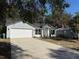 Newly built home with gray brick accents and a teal front door at 911 Pine Ave, Mount Dora, FL 32757