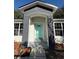 Modern home with a teal front door and gray brick archway at 911 Pine Ave, Mount Dora, FL 32757