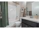 Clean bathroom with shower/tub combo and dark vanity at 1012 Sadie Ridge Rd, Clermont, FL 34715