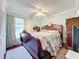 Bedroom with wooden bed frame, carpet and ceiling fan at 117 Red Rose Cir, Orlando, FL 32835