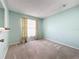 Light green bedroom with window, carpet, and floral curtains at 117 Red Rose Cir, Orlando, FL 32835