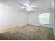 Bright bedroom with window, carpet, and ceiling fan at 117 Red Rose Cir, Orlando, FL 32835