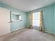 Bedroom with mirrored wall, carpet and floral curtains at 117 Red Rose Cir, Orlando, FL 32835