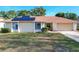 One-story house with solar panels and a landscaped yard at 117 Red Rose Cir, Orlando, FL 32835