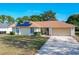 One-story house with solar panels, attached garage, and well-maintained lawn at 117 Red Rose Cir, Orlando, FL 32835