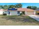 One-story house with solar panels and a landscaped yard at 117 Red Rose Cir, Orlando, FL 32835