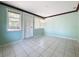 Bright Florida room with light teal walls and tile floors at 117 Red Rose Cir, Orlando, FL 32835