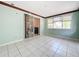 Bright Florida room with light teal walls and tile floors at 117 Red Rose Cir, Orlando, FL 32835