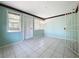 Bright Florida room with light teal walls and tile floors at 117 Red Rose Cir, Orlando, FL 32835