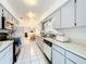 Open concept kitchen with stainless steel appliances and a view of the dining area at 117 Red Rose Cir, Orlando, FL 32835