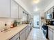 Kitchen with light gray cabinets, stainless steel appliances, and view of laundry area at 117 Red Rose Cir, Orlando, FL 32835