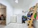 Laundry room with washer, dryer, and shelving at 117 Red Rose Cir, Orlando, FL 32835