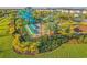 Aerial view of resort-style pool with waterslides, cabanas, and lush landscaping at 1636 Moon Valley Dr, Davenport, FL 33896
