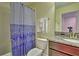 Clean bathroom with shower/tub combo, granite vanity, and patterned shower curtain at 1636 Moon Valley Dr, Davenport, FL 33896