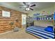 Bunk beds with nautical theme, wood-look walls, and porthole decorations at 1636 Moon Valley Dr, Davenport, FL 33896