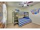 Bunk beds with nautical theme, wood-look walls, and porthole decorations at 1636 Moon Valley Dr, Davenport, FL 33896
