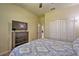 Bedroom with TV, dresser, and patterned bedding at 1636 Moon Valley Dr, Davenport, FL 33896