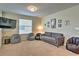 Cozy bonus room with gray sofa, beanbag chairs, and framed art at 1636 Moon Valley Dr, Davenport, FL 33896