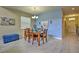 Charming dining room with a wooden table and blue accents at 1636 Moon Valley Dr, Davenport, FL 33896