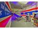 Game room features arcade games, basketball game, and fun decor at 1636 Moon Valley Dr, Davenport, FL 33896