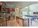 Open concept kitchen with island and stainless steel appliances at 1636 Moon Valley Dr, Davenport, FL 33896