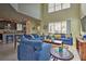 Large living room with high ceilings and blue sofas at 1636 Moon Valley Dr, Davenport, FL 33896
