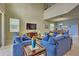 Open living area with comfortable seating and a large TV at 1636 Moon Valley Dr, Davenport, FL 33896