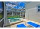 Private screened pool and spa with lounge chairs at 1636 Moon Valley Dr, Davenport, FL 33896