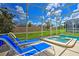 Relaxing pool and spa with lounge chairs at 1636 Moon Valley Dr, Davenport, FL 33896