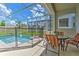 Enjoy the screened pool, patio table and chairs at 1636 Moon Valley Dr, Davenport, FL 33896