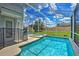 Inviting screened-in pool and spa area with lush landscaping at 1636 Moon Valley Dr, Davenport, FL 33896
