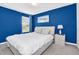 Bedroom with queen bed, blue walls, and a window at 1804 Gobi Dr, Kissimmee, FL 34747